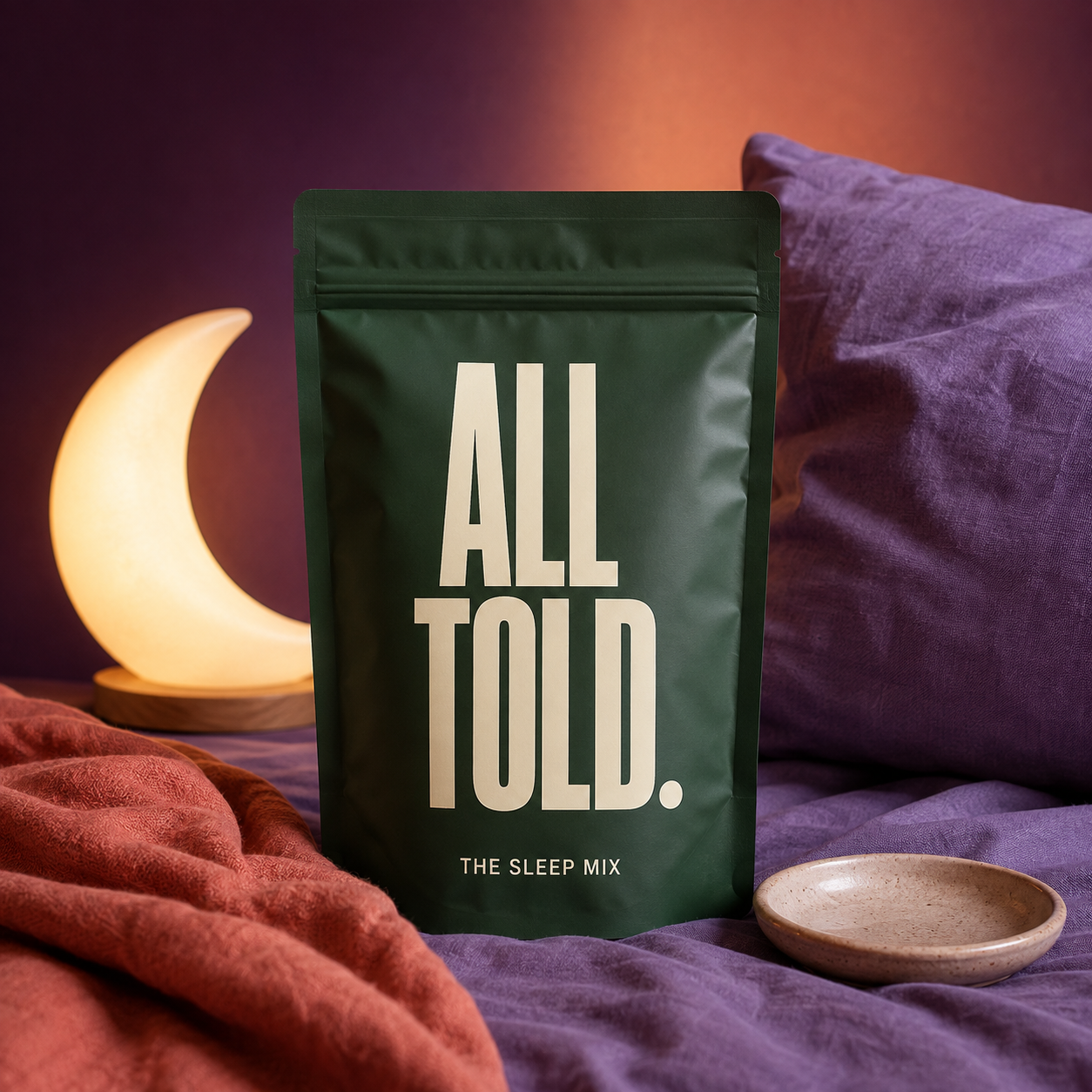 The Sleep Mix beside a glowing moon lamp and soft bedding
