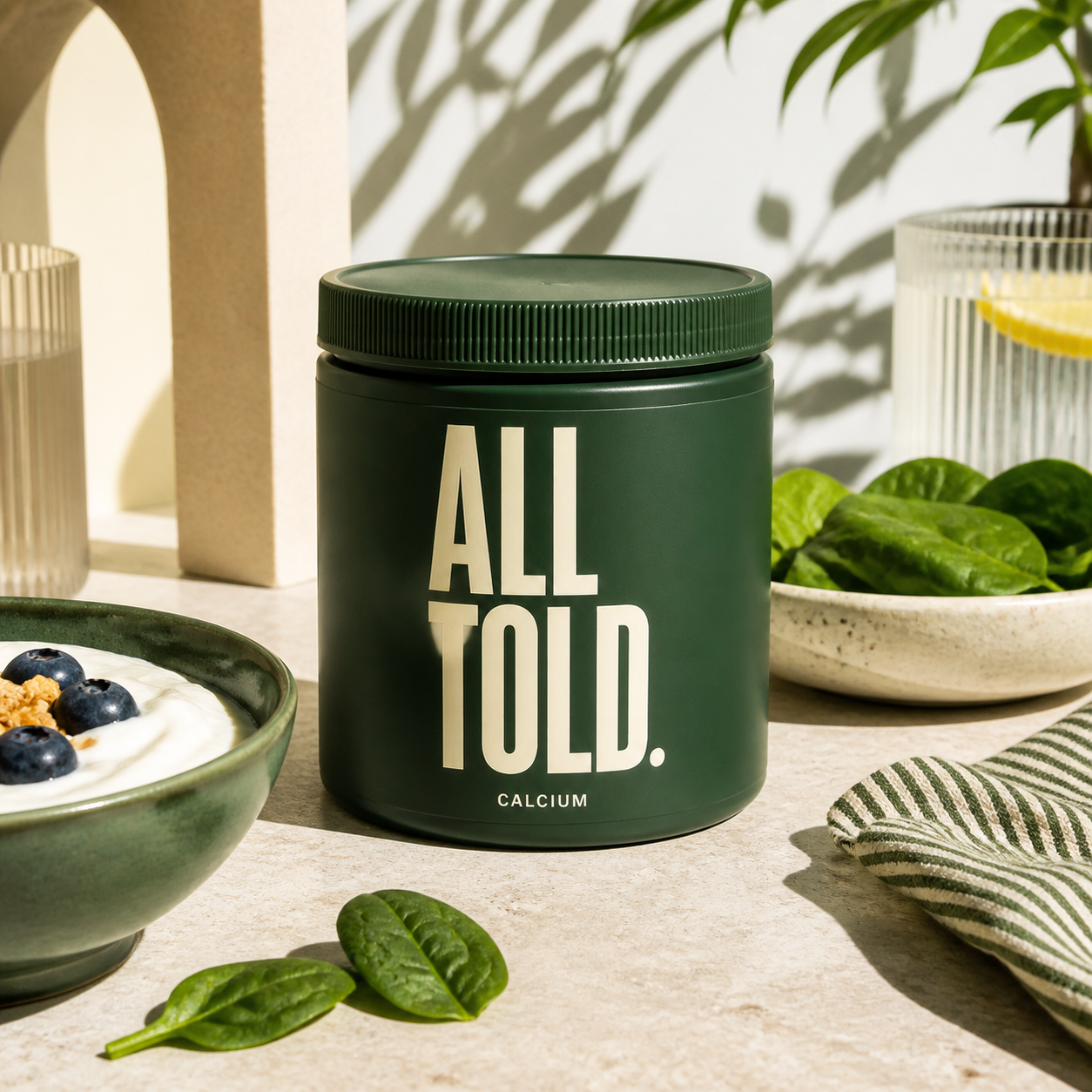 CALCIUM — ALL TOLD supplement packaging shown in a purpose-led setting
